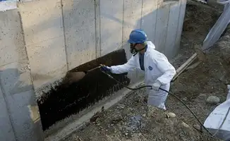 Professional waterproofing the exterior walls of the basement in Anchorage, AK