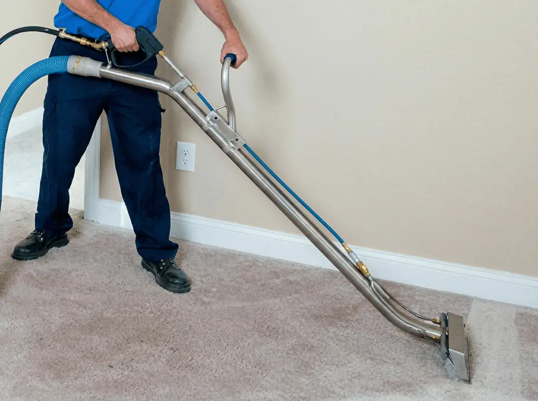 Professional operating a liquid removal machine on a carpeted floor in Anchorage, AK